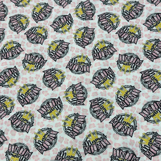 Nature's Fabrics white fabric with repetitive Mama and Mini pink and yellow text print