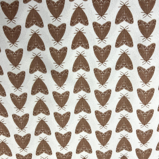 Brown moth pattern on white natural fabric by Nature's Fabrics