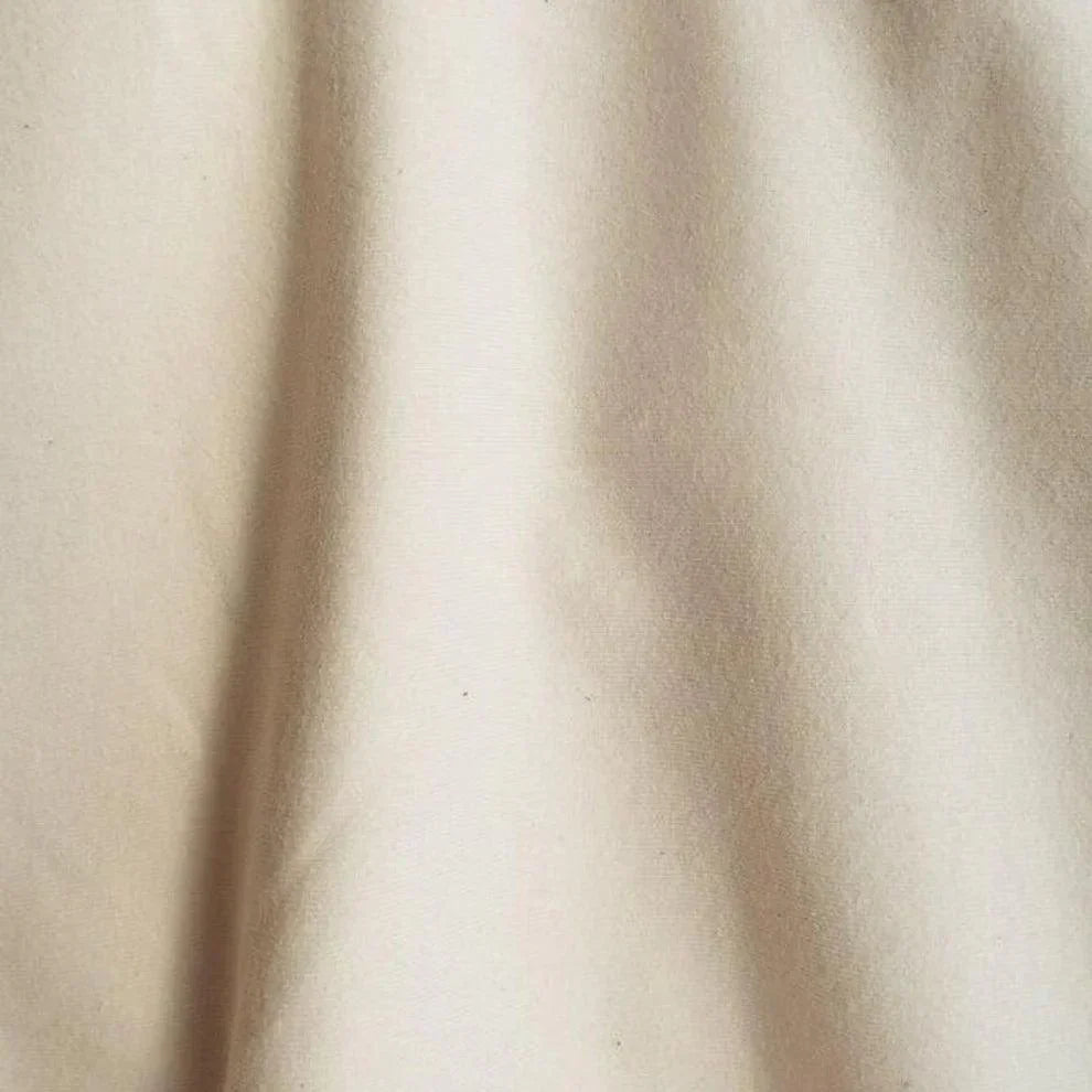Close-up of cream-colored natural fabric from Nature's Fabrics.