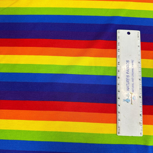 Nature's Fabrics rainbow striped organic cotton fabric with a ruler for scale