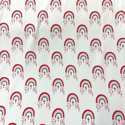 Nature's Fabrics white cotton fabric with a red, blue, and grey rainbow pattern.