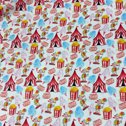 Nature's Fabrics cotton fabric with a colorful circus pattern featuring tents, popcorn, and clowns.