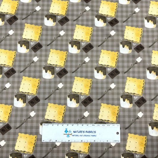 Nature's Fabrics organic cotton fabric with a s'mores print on a brown gingham background.