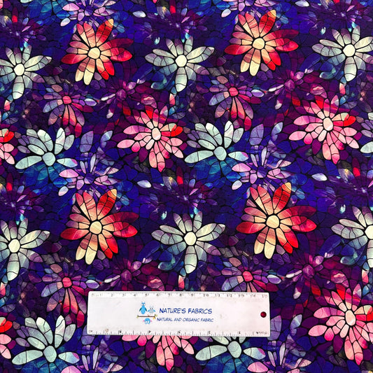 Nature's Fabrics stained glass style floral pattern fabric in purple, red, and blue.