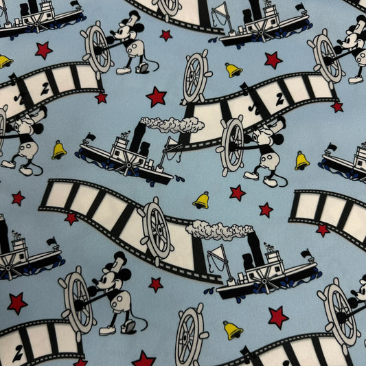Nature's Fabrics blue cotton fabric with Mickey Mouse steamboat and film strip pattern