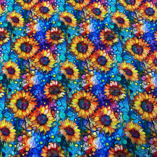 Vibrant sunflower print fabric with blue and purple watercolor background by Nature's Fabrics.