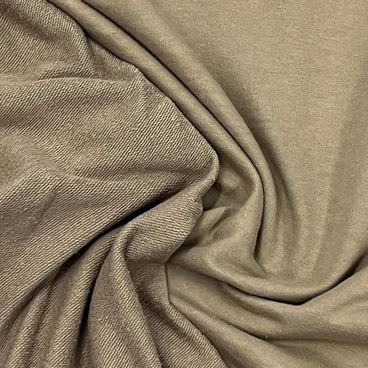 Close-up of draped taupe organic cotton fabric from Nature's Fabrics