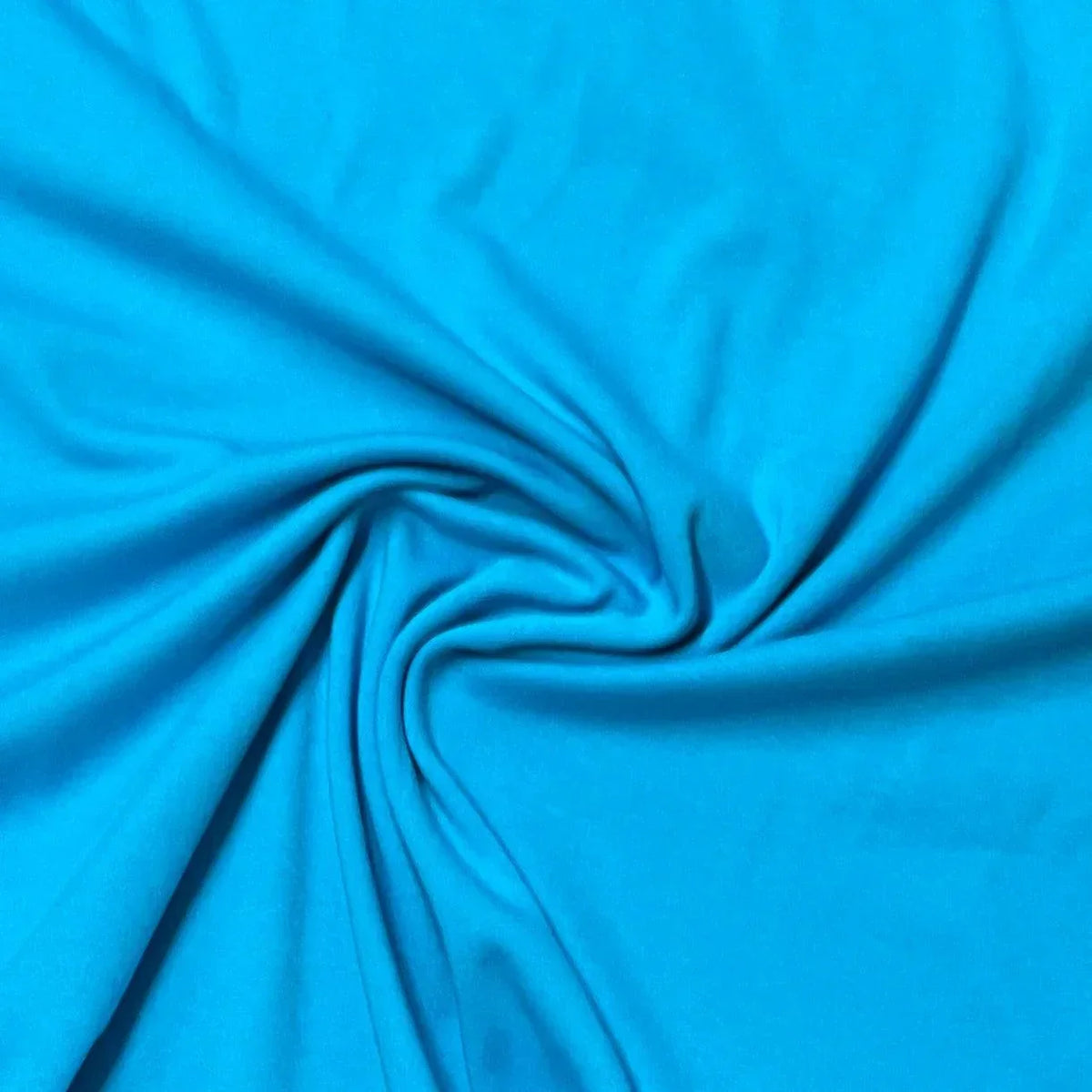Close-up of draped bright blue natural fabric from Nature's Fabrics.