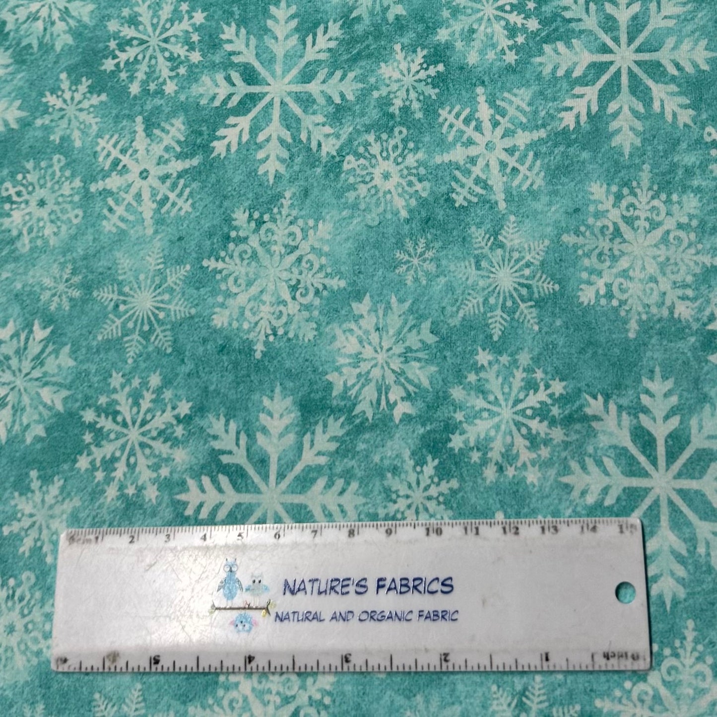 White Snowflakes on Aqua Organic Cotton/Spandex Jersey Fabric - Nature's Fabrics