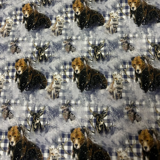Nature's Fabrics material featuring a pattern of bears and deer in a snowy forest landscape.