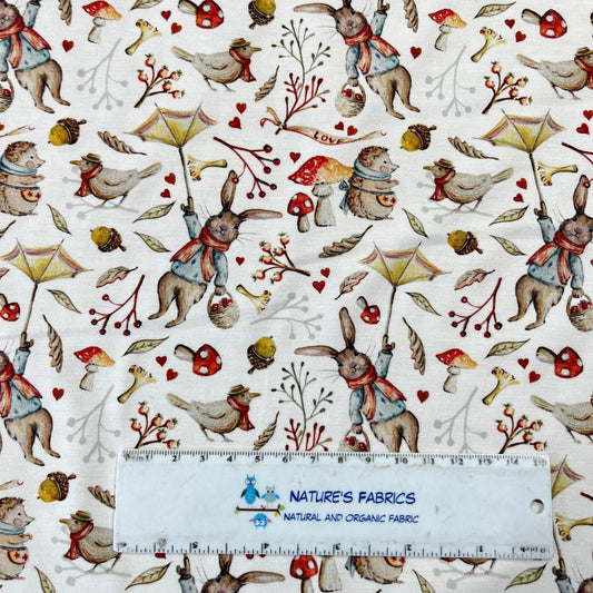 Nature's Fabrics organic cotton fabric with woodland animals, mushrooms, and umbrellas pattern.