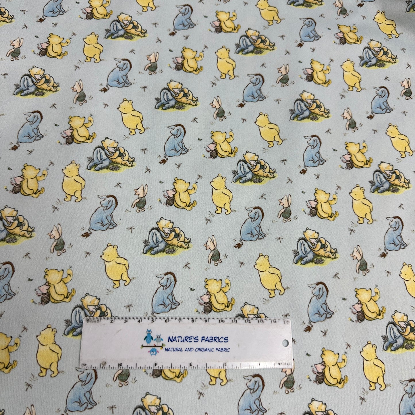 Winnie the Pooh and Friends on Blue 1 mil PUL Fabric - Made in the USA - Nature's Fabrics