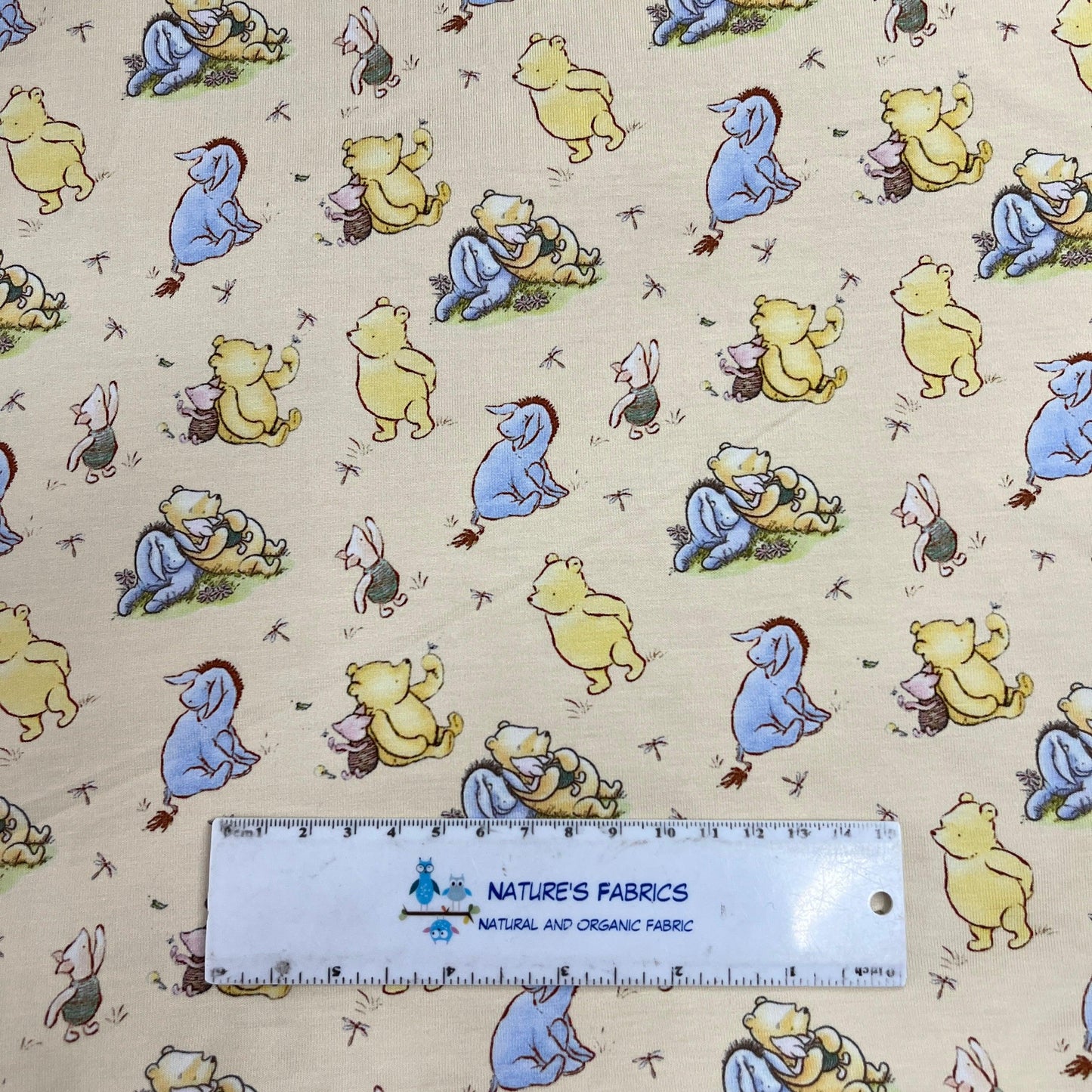 Winnie the Pooh and Friends on Yellow Bamboo/Spandex Jersey Fabric - Nature's Fabrics