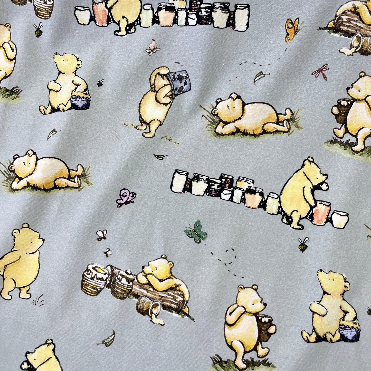 Winnie the Pooh and Honey Pots on Green Bamboo/Spandex Jersey Fabric - Nature's Fabrics