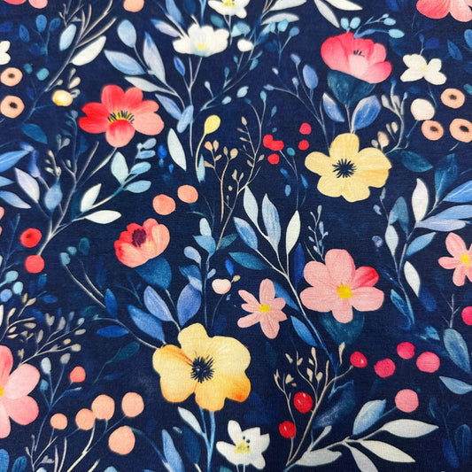 Nature's Fabrics navy blue floral print fabric with pink and yellow blossoms.