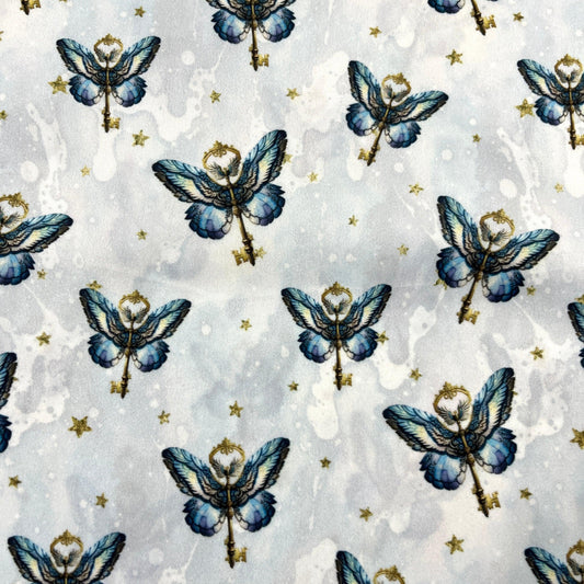 Nature's Fabrics blue butterfly key pattern on light grey watercolor background