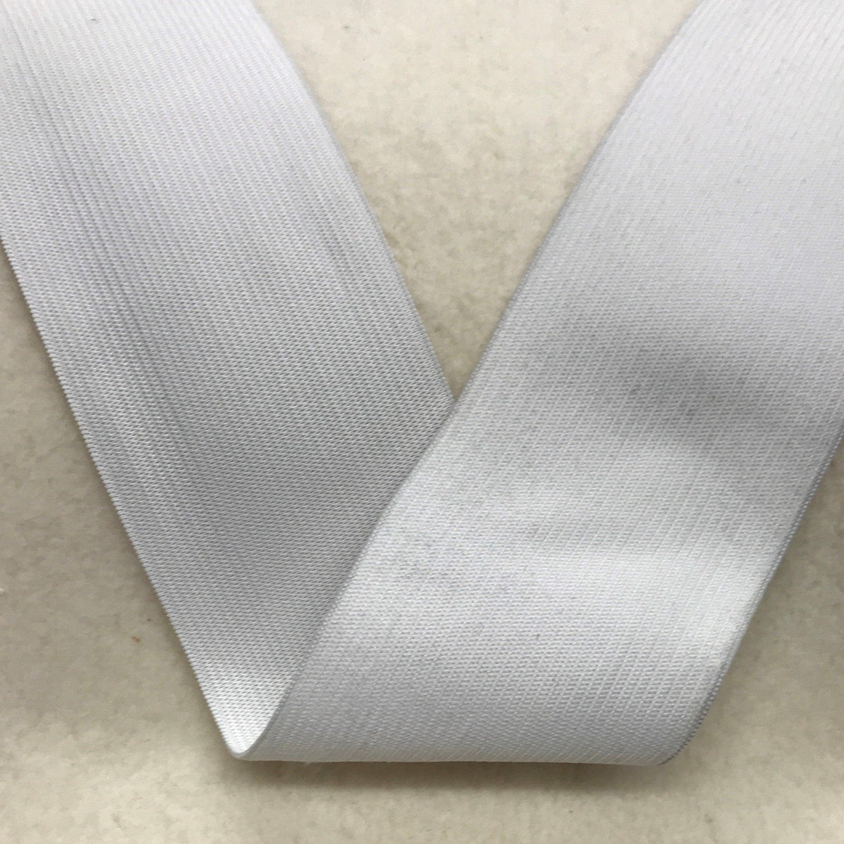 Close-up of white Nature's Fabrics woven ribbon fabric.