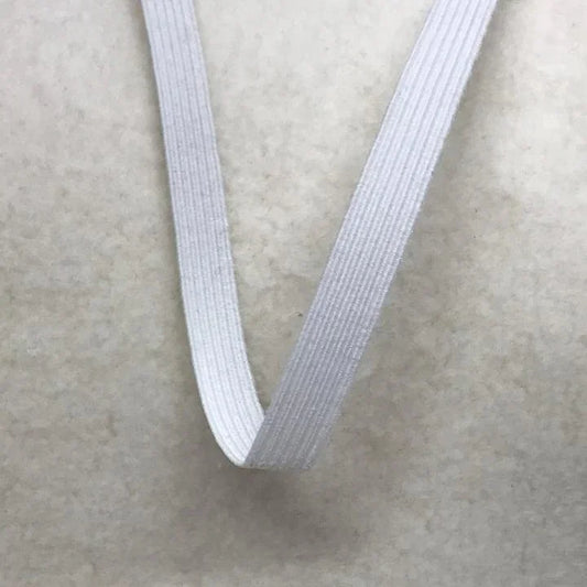 Nature's Fabrics white elastic band on a neutral fabric background