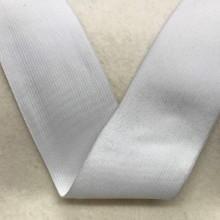 White Nature's Fabrics cotton ribbon folded on a neutral background