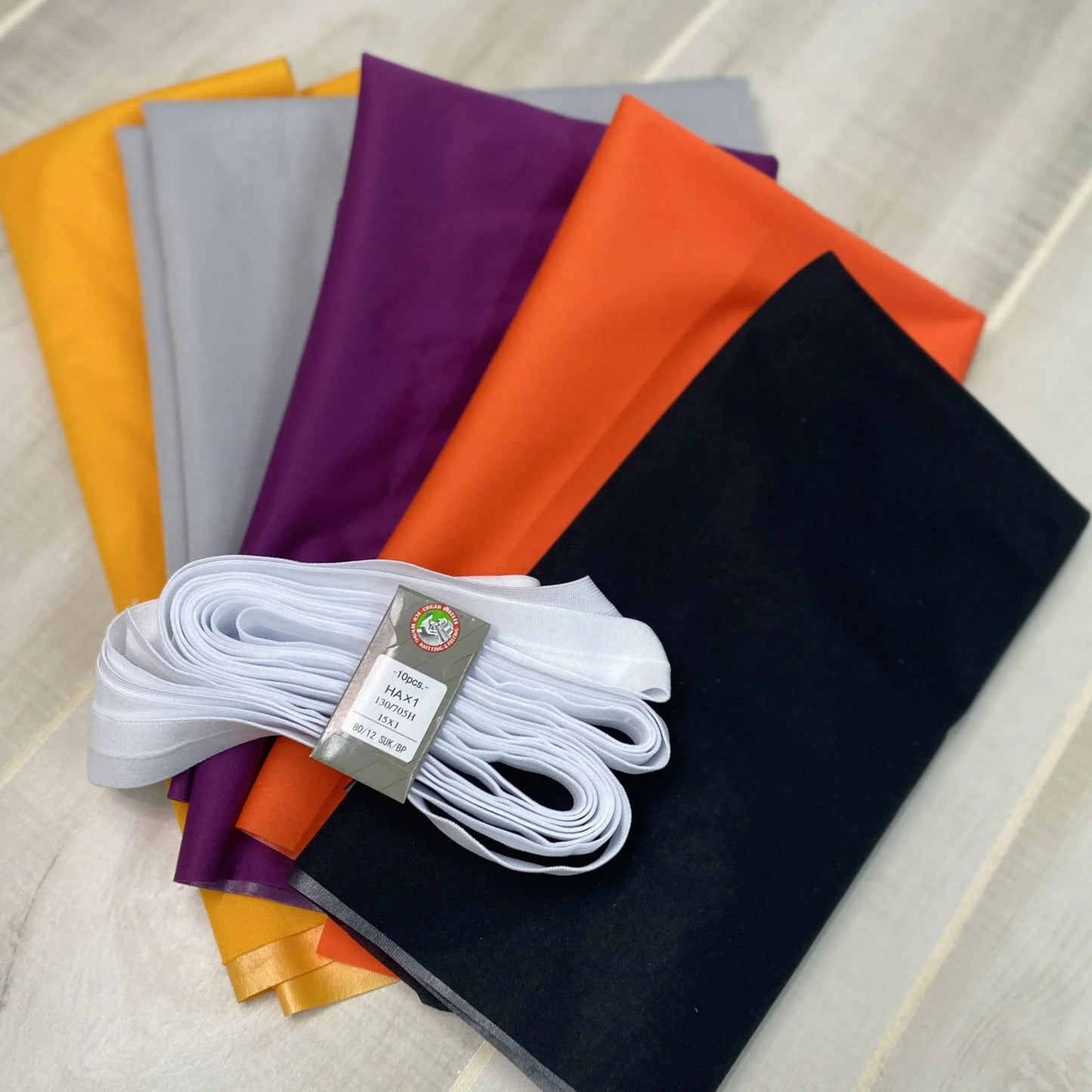 Nature's Fabrics premium colorful fabric swatches in yellow, grey, purple, orange, and black.