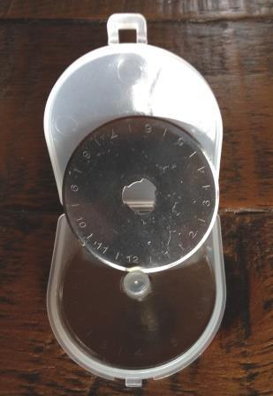 Nature's Fabrics plastic measuring tool with numbered dial on a wooden surface