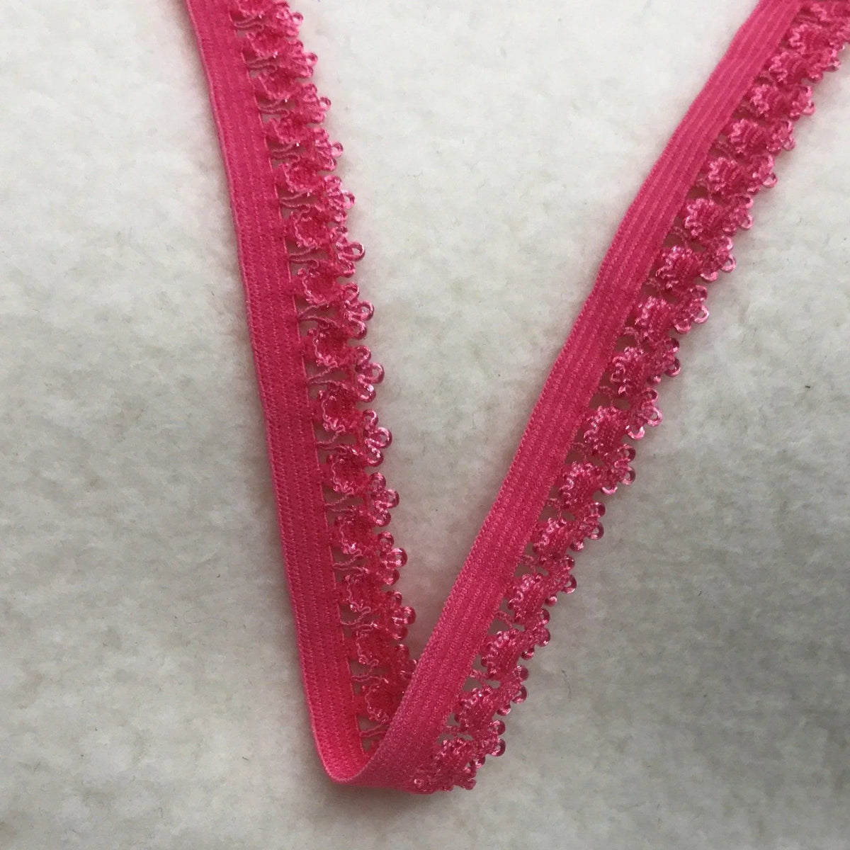 Nature's Fabrics bright pink elastic trim with delicate scalloped lace edging