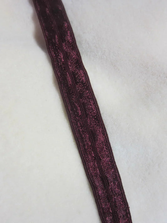Nature's Fabrics deep burgundy patterned ribbon on a white fabric background