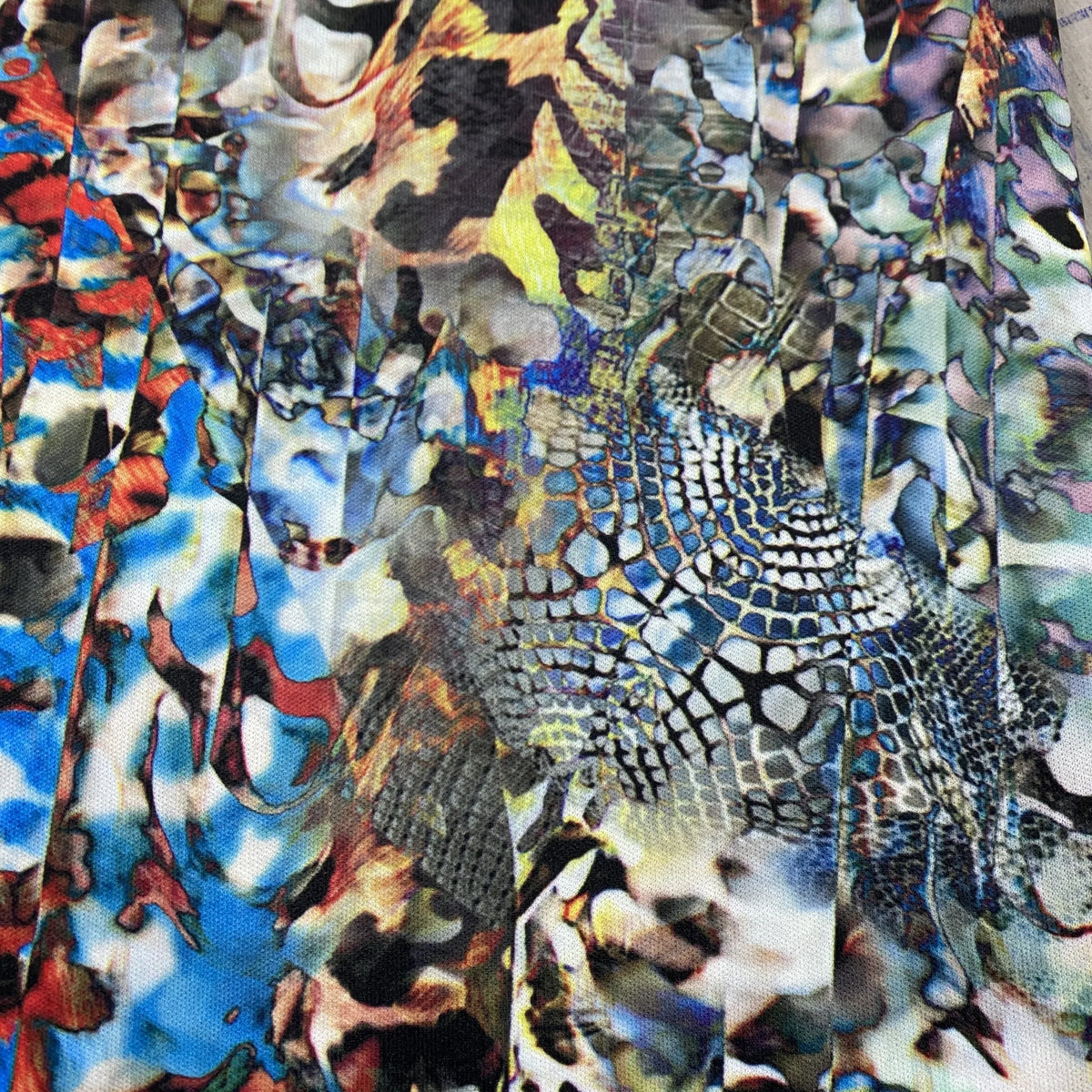 Close-up of Nature's Fabrics multicolored abstract animal print fabric with scales and spots.