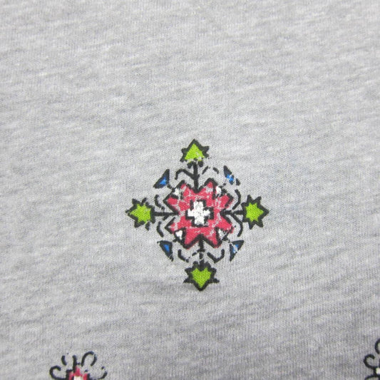 Close-up of a colorful floral geometric pattern on grey Nature's Fabrics material.