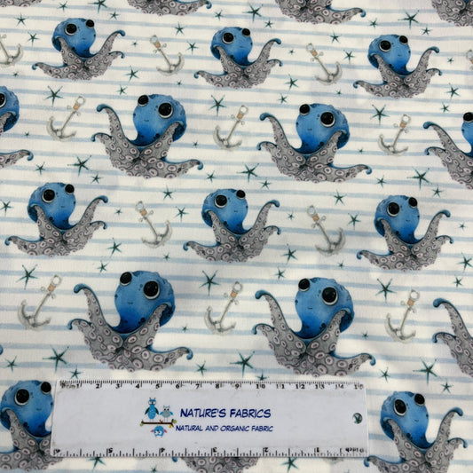 Nature's Fabrics organic cotton fabric featuring blue octopuses and anchors on a striped background.
