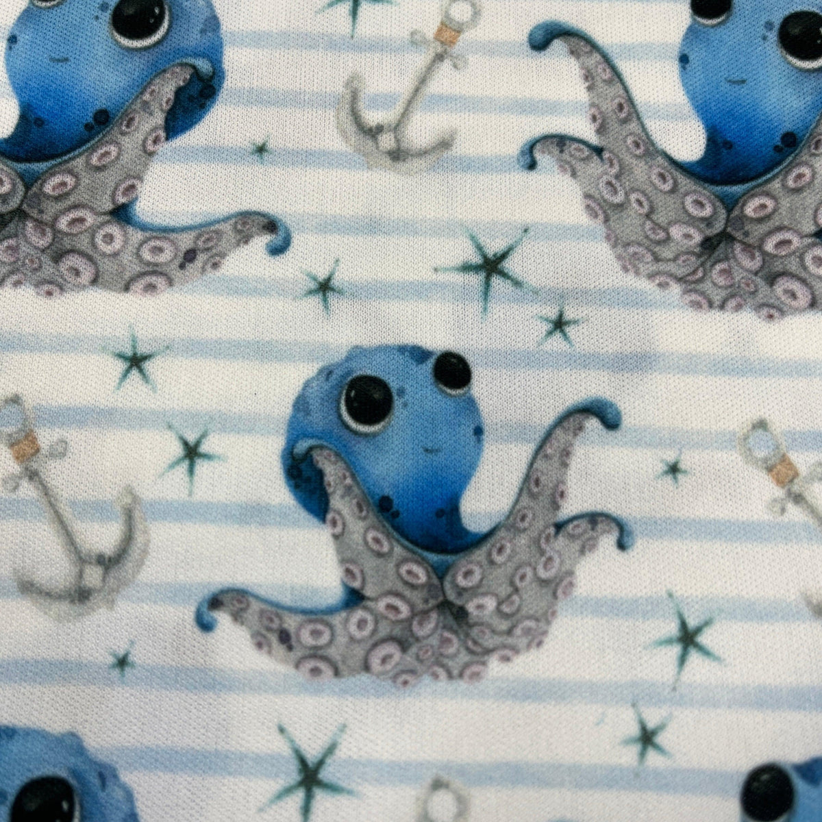 Nature's Fabrics blue octopus and anchor pattern on white striped organic cotton fabric