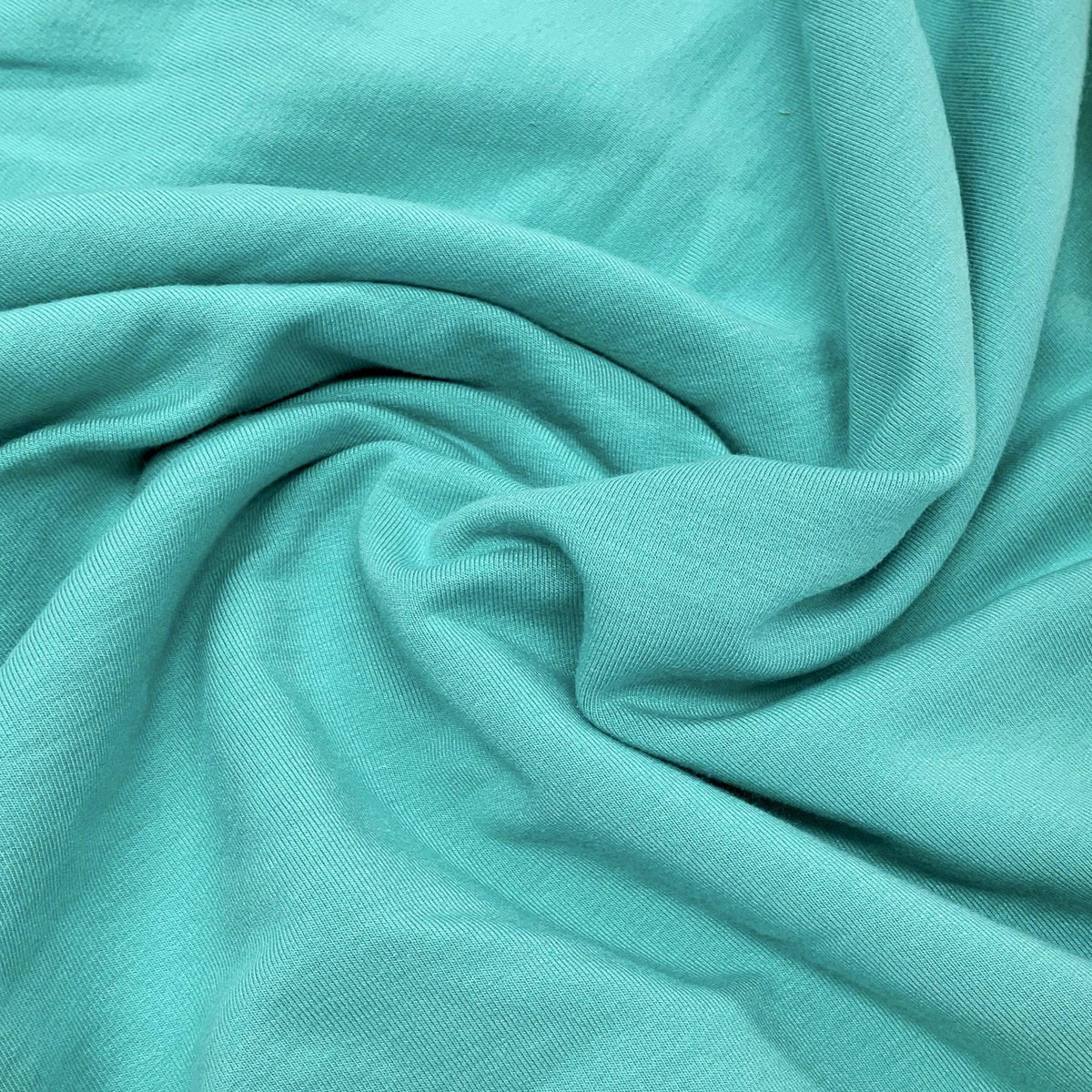 Draped teal-colored organic fabric from Nature's Fabrics