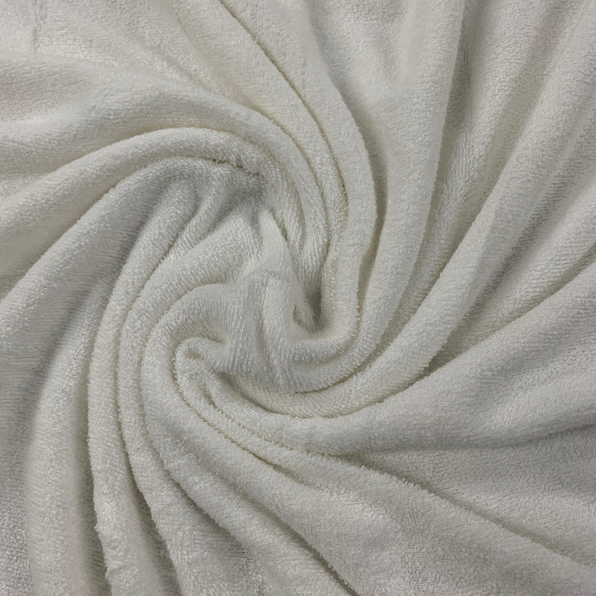 Close-up of swirled white organic cotton fabric from Nature's Fabrics.