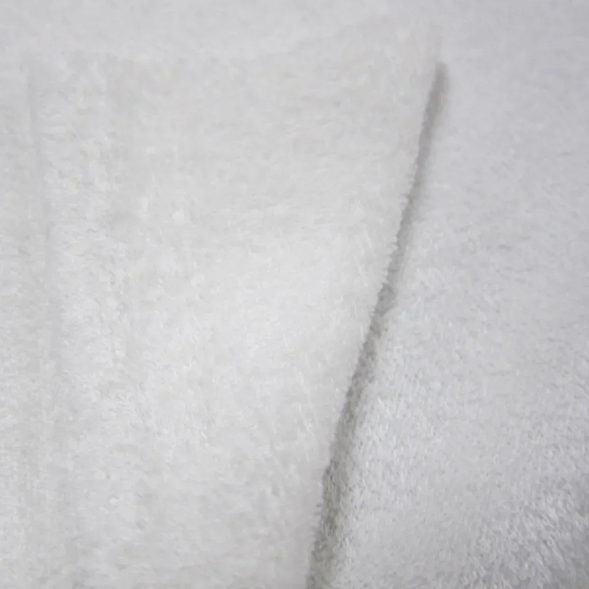 Close-up of soft, white textured natural fabric from Nature's Fabrics