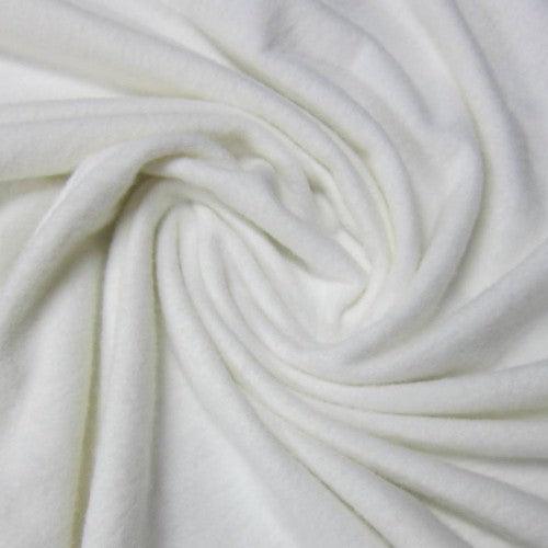 Close-up of white organic fabric from Nature's Fabrics draped in soft folds.