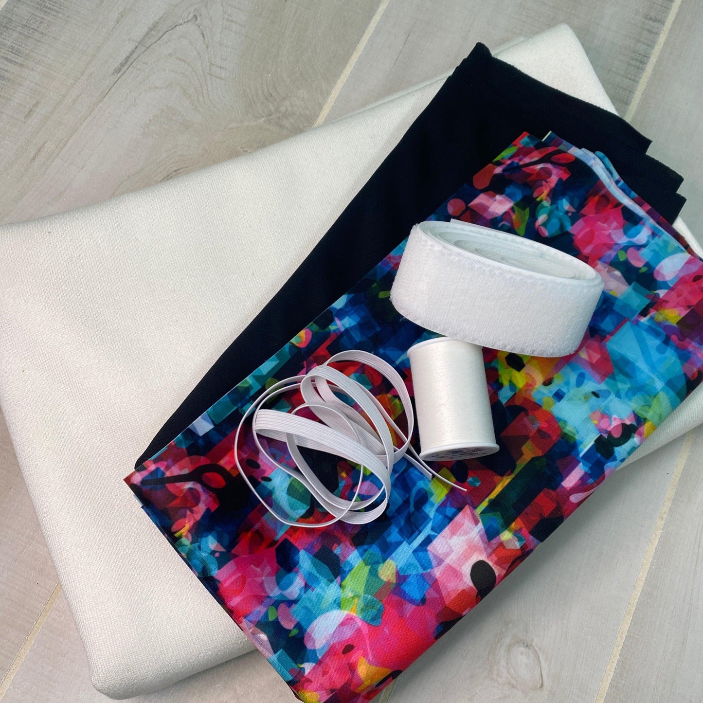 Nature's Fabrics assortment of white, black, and colorful abstract printed fabrics with sewing supplies