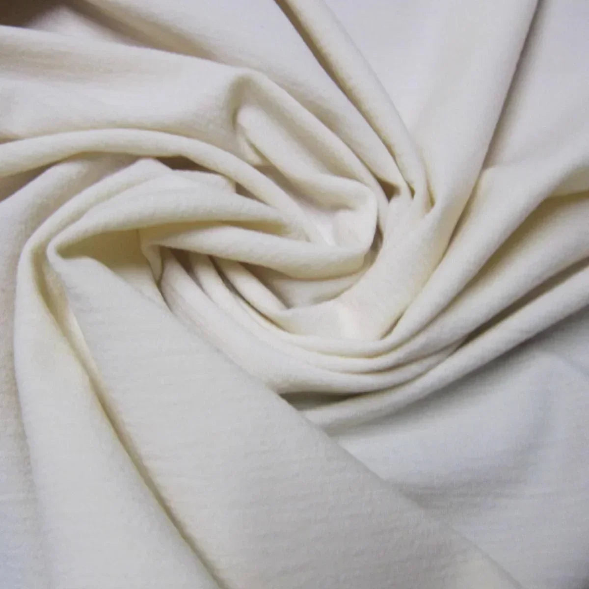 Nature's Fabrics premium off-white organic cotton fabric draped in soft folds