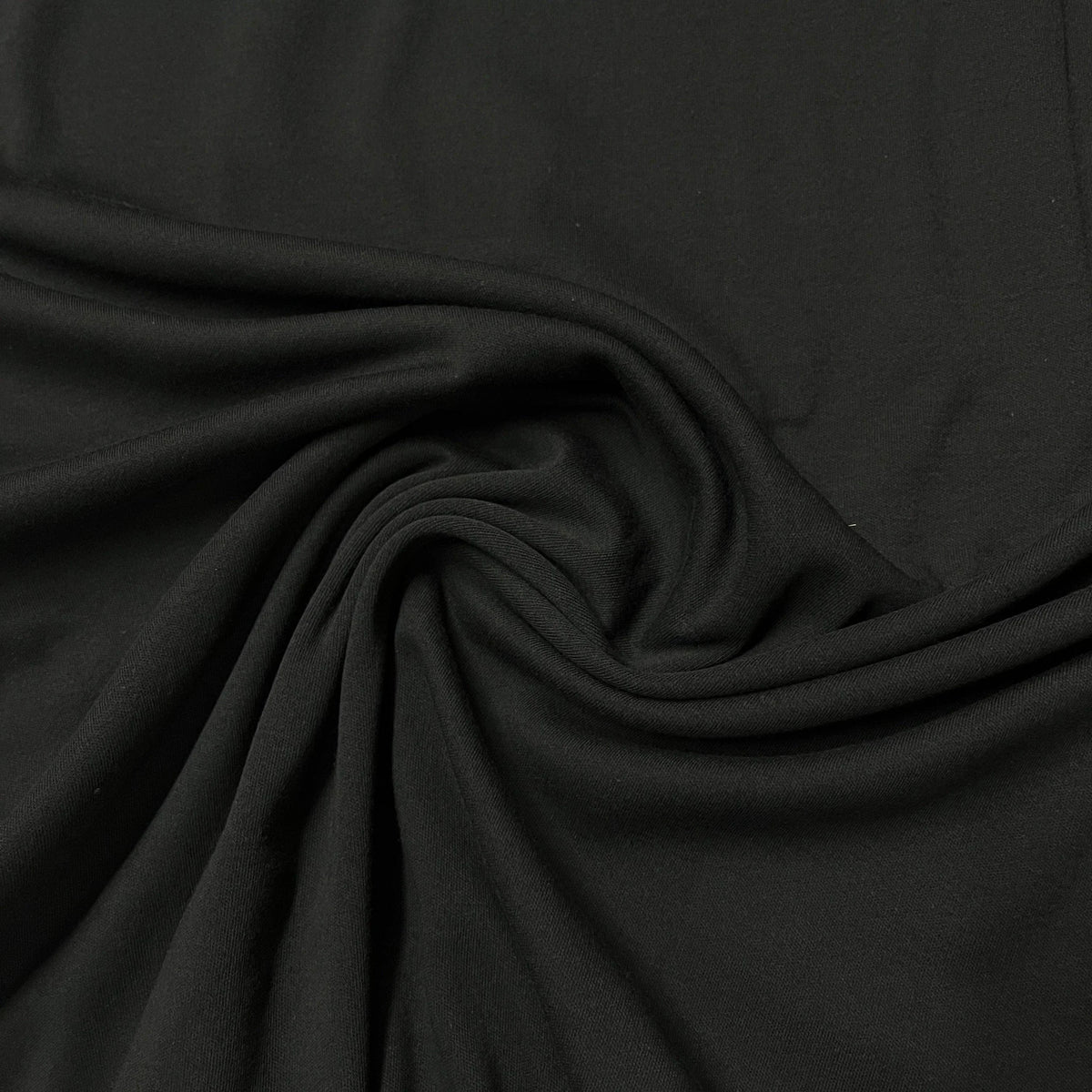 Close-up of draped black premium natural fabric from Nature's Fabrics.