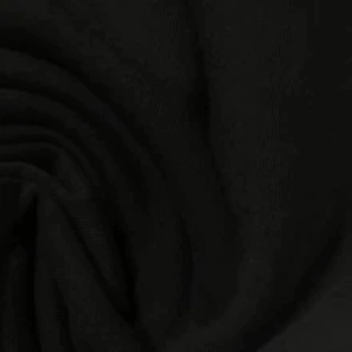 Close-up of black Nature's Fabrics natural fabric with soft folds.