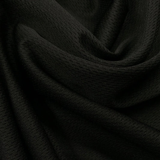 Close-up of draped black textured fabric from Nature's Fabrics