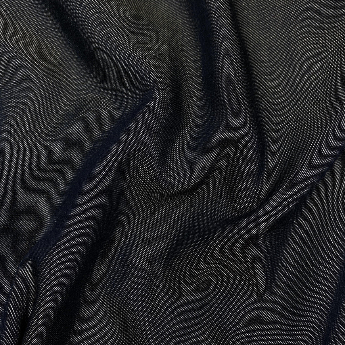 Close-up of draped dark navy blue premium fabric from Nature's Fabrics.