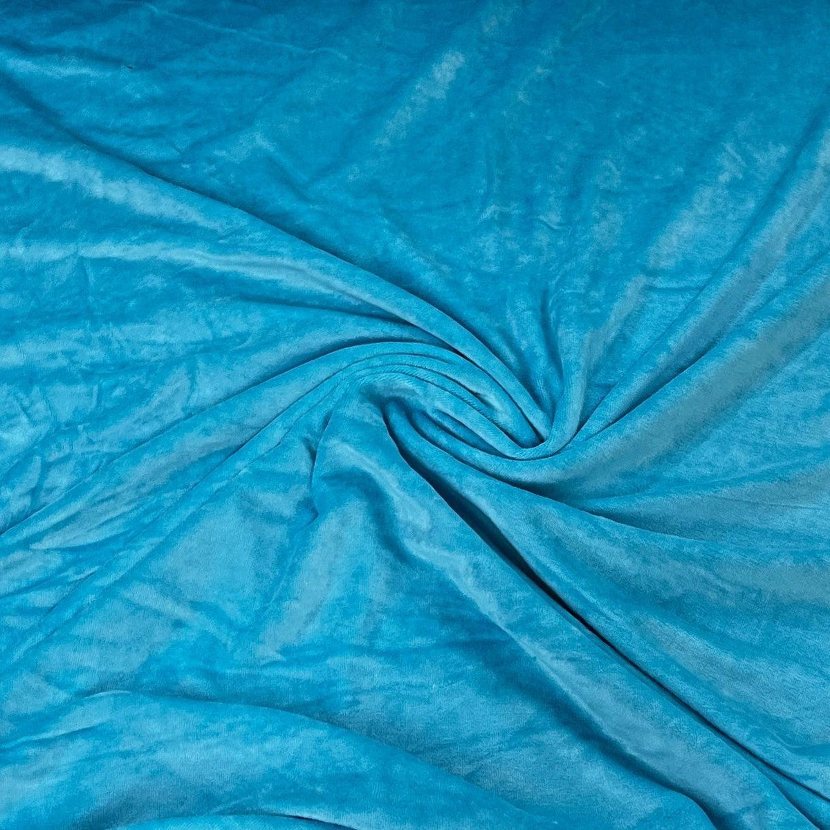Nature's Fabrics turquoise blue textured fabric swirled in a spiral pattern
