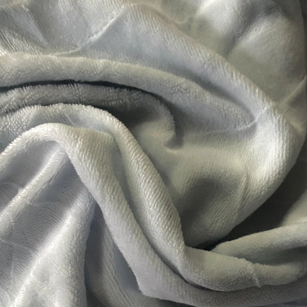 Close-up of soft, light blue plush fabric folds from Nature's Fabrics.