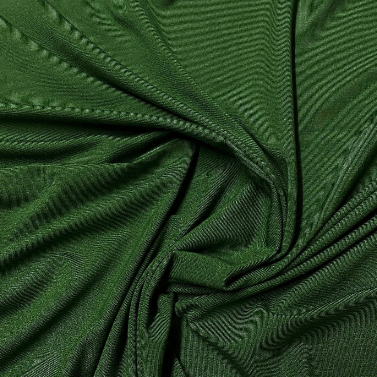 Nature's Fabrics premium green organic fabric with soft folds and draped texture.