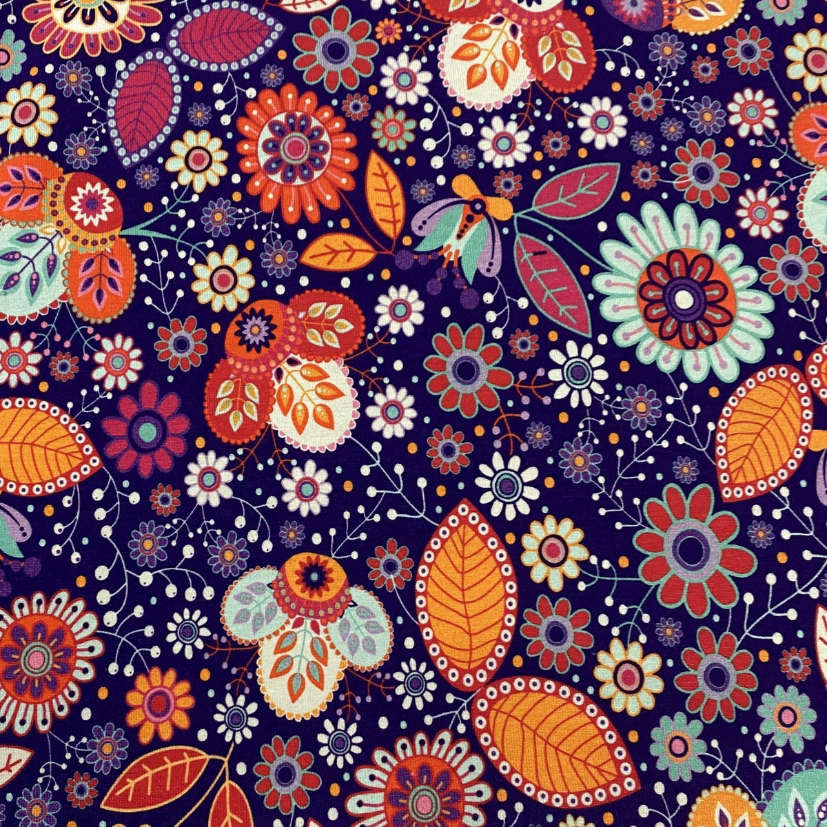 Nature's Fabrics floral pattern fabric with colorful blossoms and leaves on a dark purple background