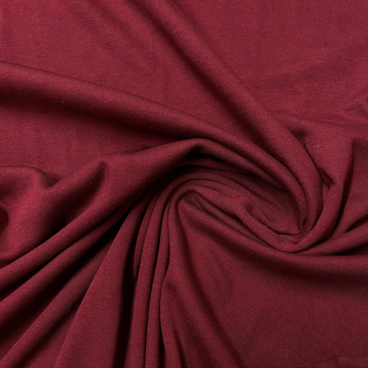 Burgundy red natural fabric draped in folds from Nature's Fabrics