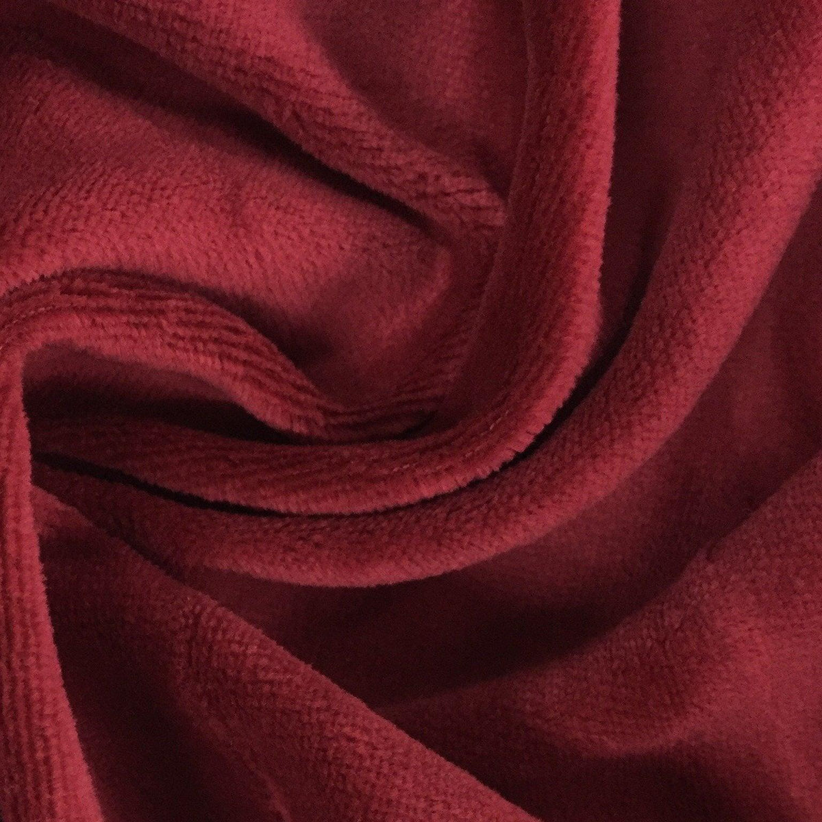 Close-up of draped deep red velvet fabric from Nature's Fabrics