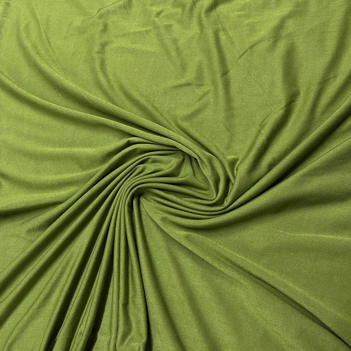 Olive green natural fabric draped in a swirl from Nature's Fabrics