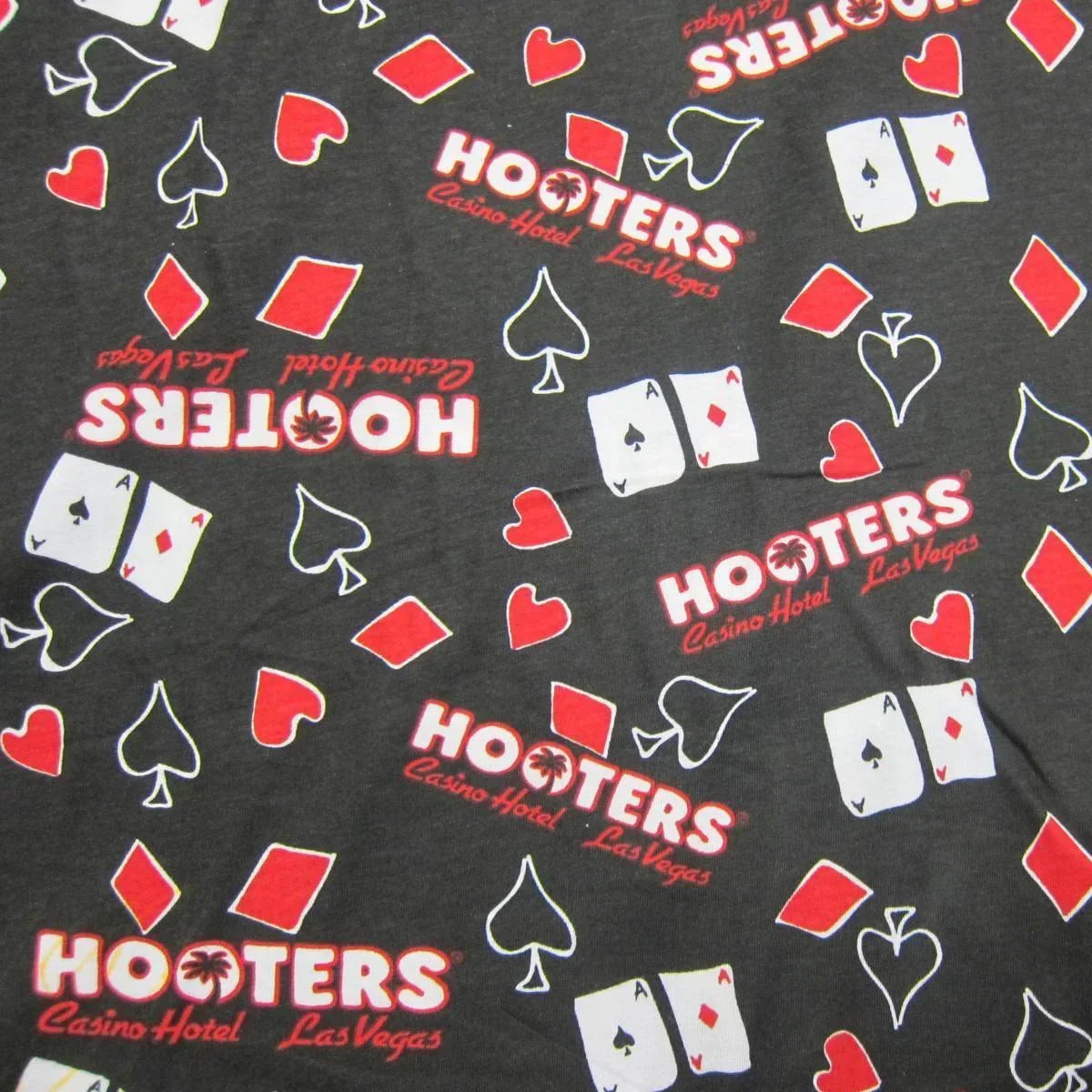 Black Hooters Casino Hotel Las Vegas fabric with red and white playing card suit patterns.