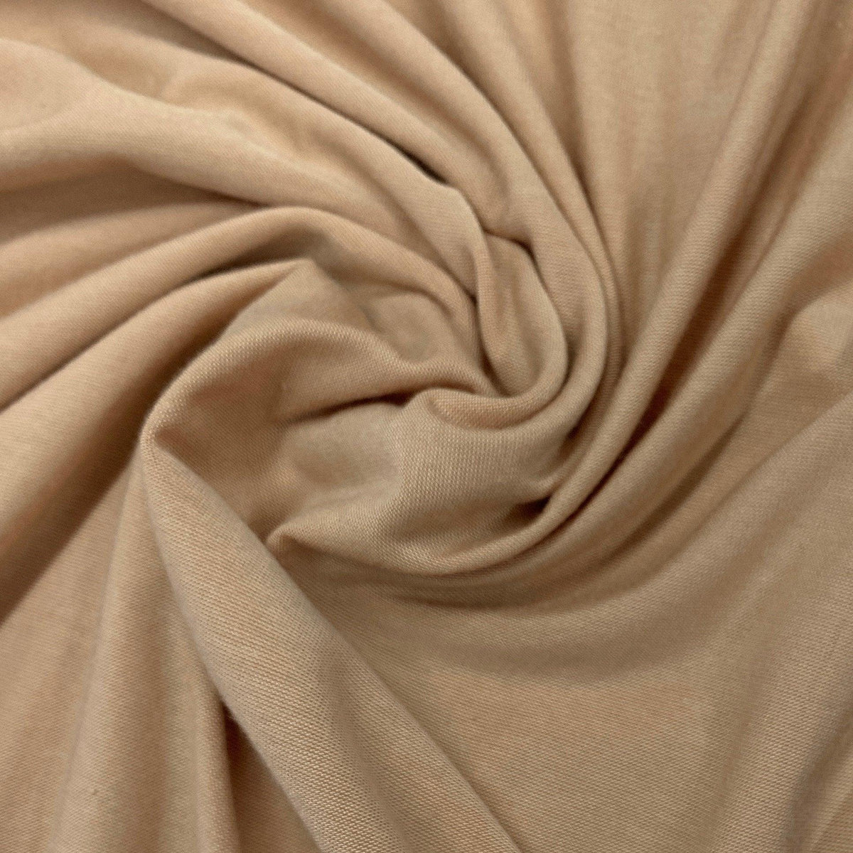 Close-up of draped, beige natural fabric by Nature's Fabrics